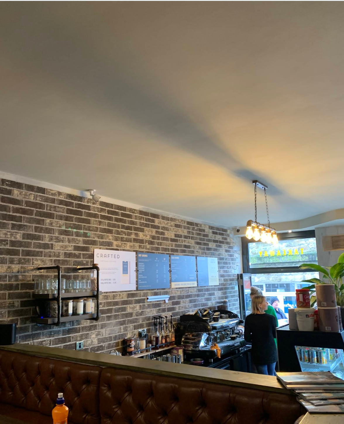 Crafted Coffee House coffee bar with warm lighting and espresso equipment
