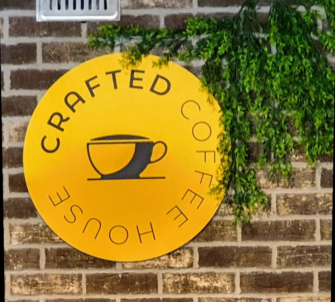 Crafted Coffee House signature yellow logo wall
